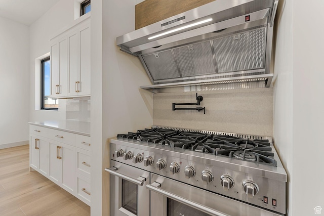 1762 S 920 W, Hurricane, UT 84737 - kitchen featuring range with two ovens, ventilation hood, white cabinets, and light wood-style flooring