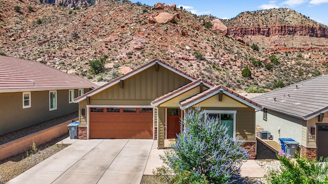 130 Matilda Ln, Springdale, UT 84767 - view of front of house featuring board and batten siding, a mountain view, concrete driveway, and an attached garage