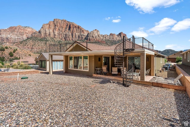 130 Matilda Ln, Springdale, UT 84767 - back of house featuring a mountain view, a patio, a balcony, and stucco siding