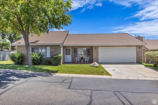1090 E 700 S Unit 24, St George, UT 84790 - single story home featuring a tile roof, a garage, brick siding, and concrete driveway