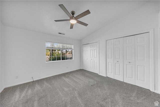 1090 E 700 S Unit 24, St George, UT 84790 - unfurnished bedroom featuring multiple closets, lofted ceiling, carpet, and ceiling fan
