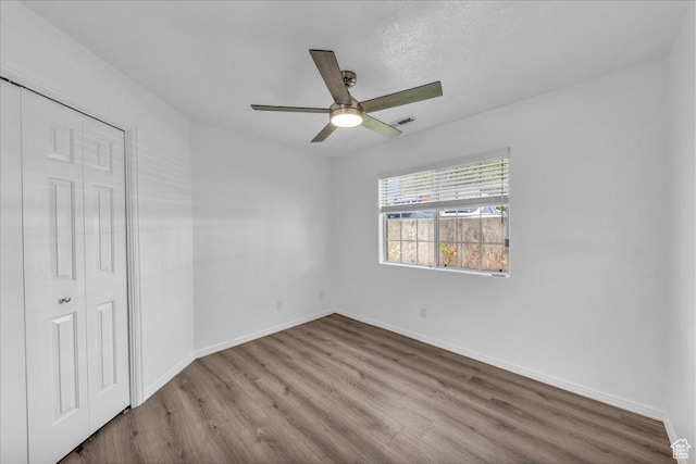 1090 E 700 S Unit 24, St George, UT 84790 - unfurnished bedroom with wood finished floors, a closet, and a ceiling fan