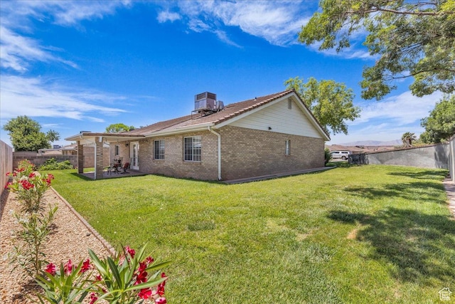 1090 E 700 S Unit 24, St George, UT 84790 - rear view of house with brick siding, a fenced backyard, and a patio