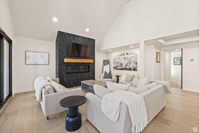 51 Daly Ave, Park City, UT 84060 - living room featuring a high end fireplace, high vaulted ceiling, light wood-type flooring, and recessed lighting