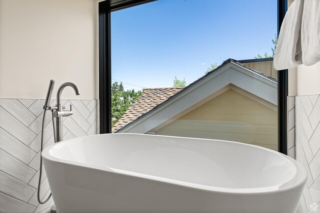 51 Daly Ave, Park City, UT 84060 - full bathroom featuring a soaking tub, tile walls, and plenty of natural light