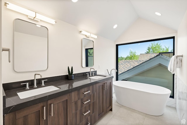 51 Daly Ave, Park City, UT 84060 - bathroom featuring double vanity, a soaking tub, vaulted ceiling, tile patterned floors, and recessed lighting