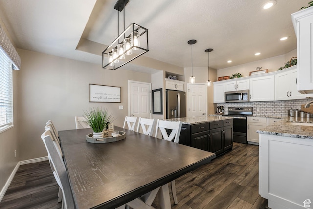6743 W Spring Oak Dr, West Jordan, UT 84081 - dining area with dark wood-style flooring and recessed lighting