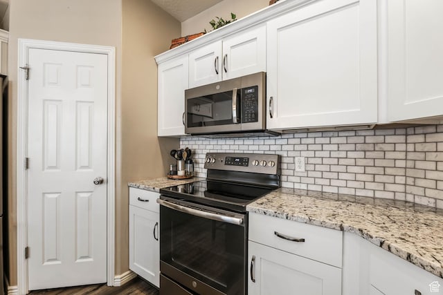 6743 W Spring Oak Dr, West Jordan, UT 84081 - kitchen with appliances with stainless steel finishes, tasteful backsplash, and white cabinetry