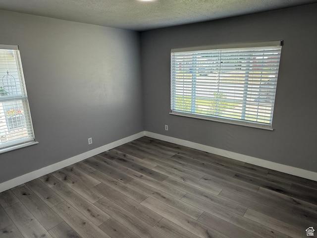 2327 S Custer E, Ogden, UT 84401 - unfurnished room with dark wood-type flooring and a textured ceiling