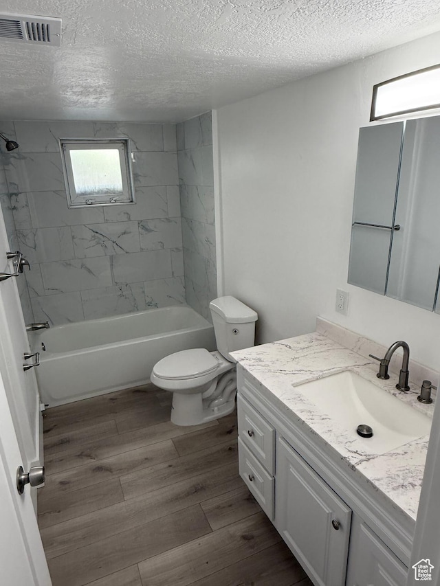 2327 S Custer E, Ogden, UT 84401 - bathroom with vanity, a textured ceiling, bathtub / shower combination, and wood finished floors