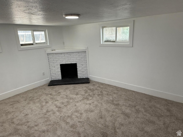 2327 S Custer E, Ogden, UT 84401 - unfurnished living room featuring a textured ceiling, a fireplace, and carpet