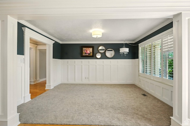 964 E Stewart Hill Dr, River Heights, UT 84321 - empty room with crown molding, carpet, wainscoting, and a decorative wall