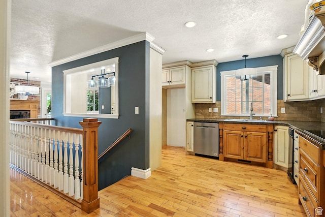 964 E Stewart Hill Dr, River Heights, UT 84321 - kitchen with dishwasher, a textured ceiling, dark countertops, decorative backsplash, and cream cabinetry