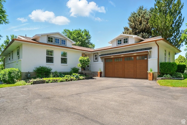 964 E Stewart Hill Dr, River Heights, UT 84321 - view of front of property with brick siding, asphalt driveway, and an attached garage
