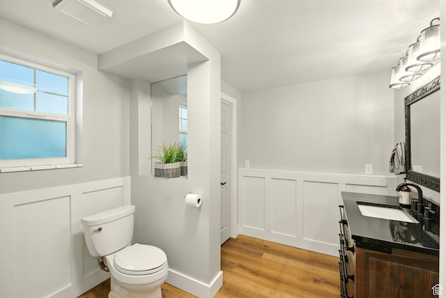 964 E Stewart Hill Dr, River Heights, UT 84321 - bathroom featuring wood finished floors, a decorative wall, wainscoting, and vanity