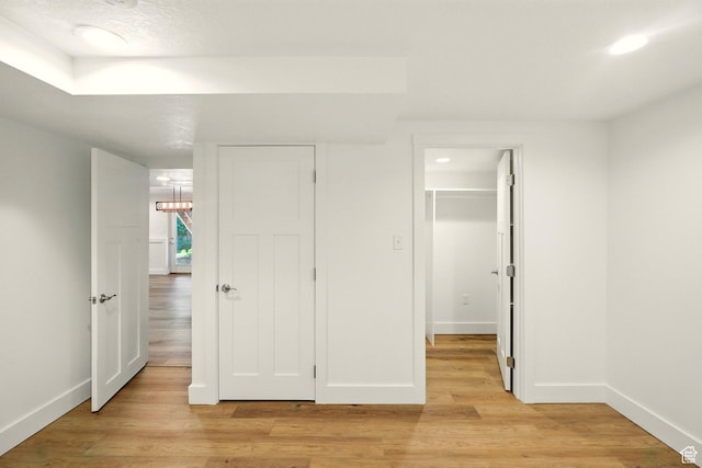 964 E Stewart Hill Dr, River Heights, UT 84321 - unfurnished bedroom with light wood-style floors, a closet, and a walk in closet
