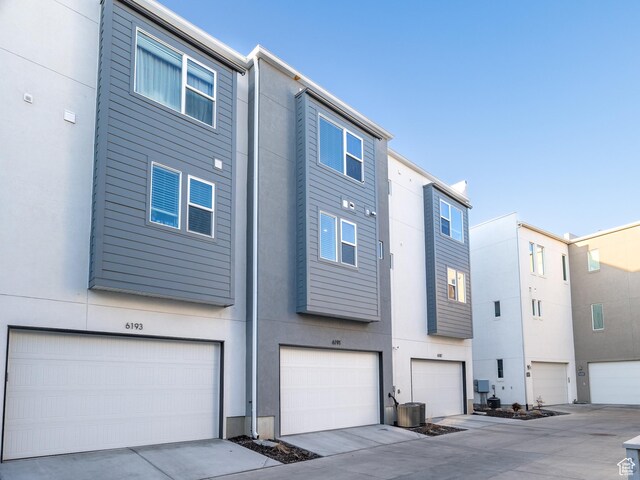 6191 W S Jordan Pkwy S Unit 286, South Jordan, UT 84009 - rear view of house featuring a garage and stucco siding