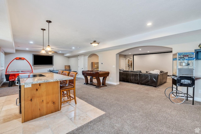 9967 N 6670 W, Highland, UT 84003 - kitchen with open floor plan, light carpet, arched walkways, recessed lighting, and a breakfast bar