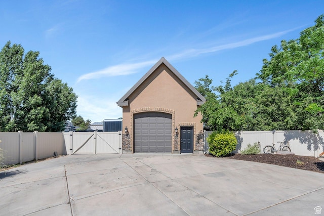 9967 N 6670 W, Highland, UT 84003 - garage featuring a gate and concrete driveway