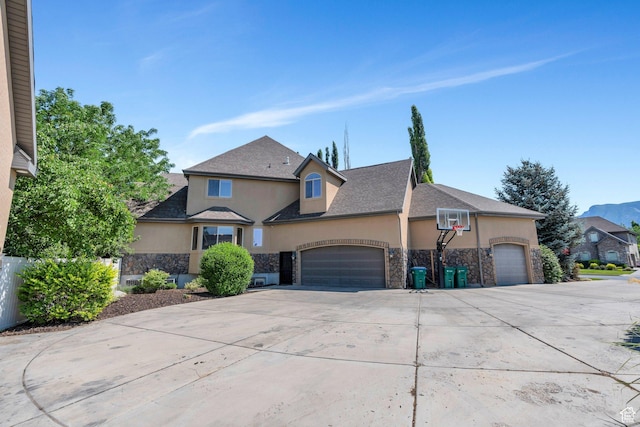 9967 N 6670 W, Highland, UT 84003 - traditional-style house featuring stone siding, stucco siding, a garage, and driveway