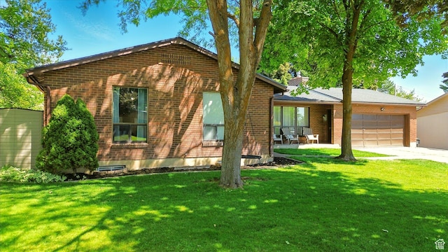 130 Summit Dr, Smithfield, UT 84335 - view of front of house featuring brick siding, a garage, a front lawn, and concrete driveway