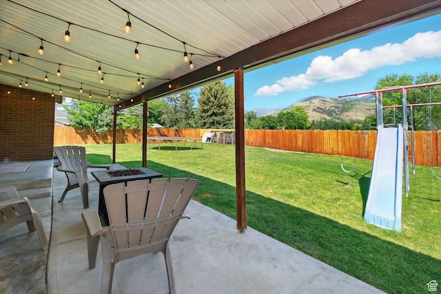 130 Summit Dr, Smithfield, UT 84335 - fenced backyard featuring a patio, a mountain view, and a fire pit