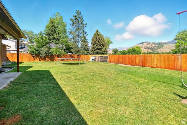 130 Summit Dr, Smithfield, UT 84335 - fenced backyard featuring a mountain view and a trampoline