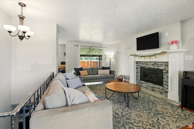 130 Summit Dr, Smithfield, UT 84335 - living room with a textured ceiling, a chandelier, a stone fireplace, and wood finished floors