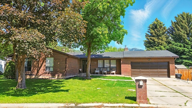 130 Summit Dr, Smithfield, UT 84335 - single story home with a garage, driveway, brick siding, and a chimney