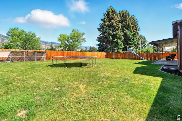 130 Summit Dr, Smithfield, UT 84335 - fenced backyard with a trampoline, a playground, and a mountain view
