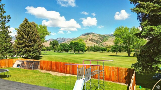 130 Summit Dr, Smithfield, UT 84335 - fenced backyard featuring a mountain view, a trampoline, and view of golf course