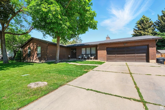 130 Summit Dr, Smithfield, UT 84335 - ranch-style home featuring brick siding, concrete driveway, an attached garage, and a front lawn