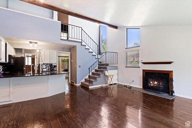 1423 S 1175 E Unit 1, Ogden, UT 84404 - unfurnished living room with a fireplace with flush hearth, dark wood-type flooring, and stairs