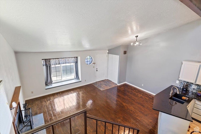 1423 S 1175 E Unit 1, Ogden, UT 84404 - foyer featuring a textured ceiling, hardwood / wood-style floors, and a chandelier