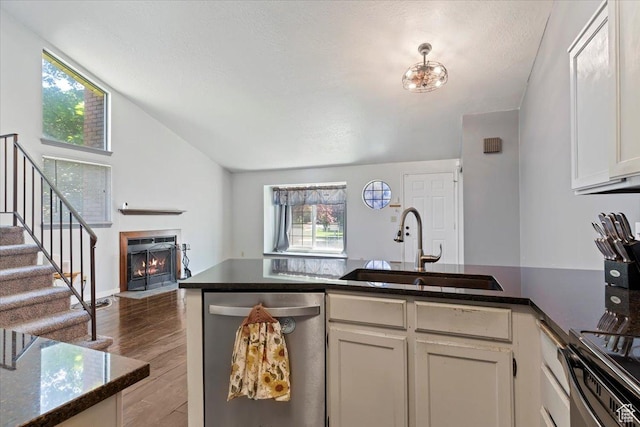 1423 S 1175 E Unit 1, Ogden, UT 84404 - kitchen with dishwasher, a fireplace with flush hearth, wood finished floors, lofted ceiling, and stove