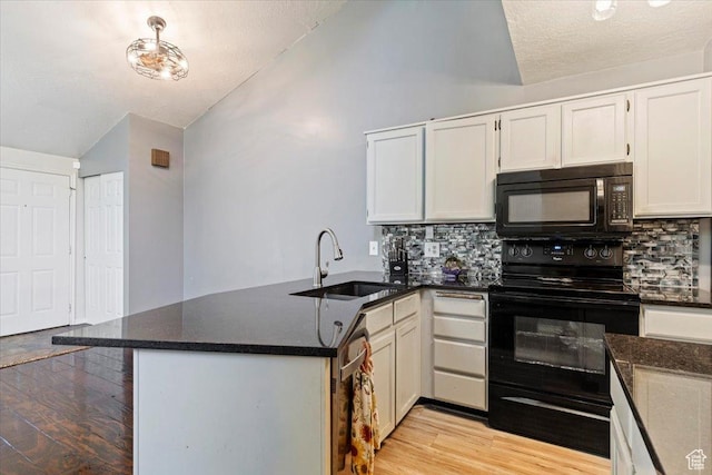1423 S 1175 E Unit 1, Ogden, UT 84404 - kitchen with black appliances, lofted ceiling, a peninsula, tasteful backsplash, and light wood finished floors