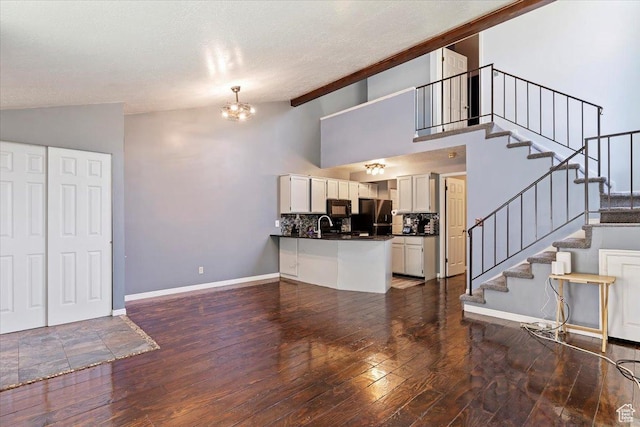 1423 S 1175 E Unit 1, Ogden, UT 84404 - unfurnished living room with hardwood / wood-style floors, stairway, a chandelier, and high vaulted ceiling