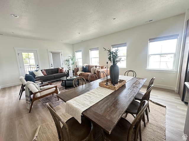 7846 S Holden St, Midvale, UT 84047 - dining area with light wood-style flooring, a textured ceiling, and recessed lighting
