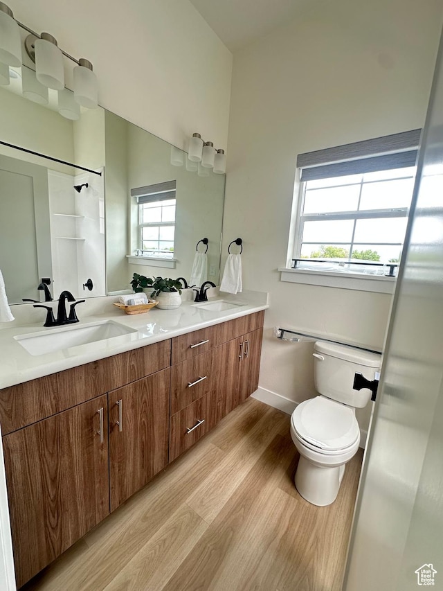 7846 S Holden St, Midvale, UT 84047 - bathroom with wood finished floors, double vanity, and a shower
