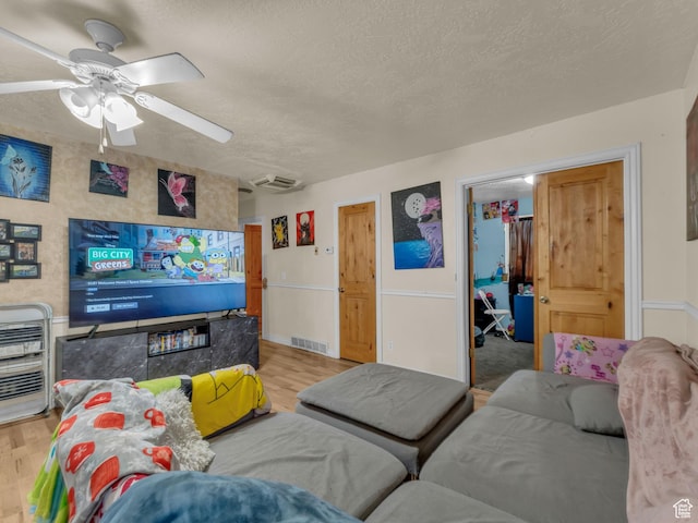6126 S Middlewood Cir W, Salt Lake City, UT 84118 - living area featuring light wood-style flooring, a textured ceiling, heating unit, and ceiling fan