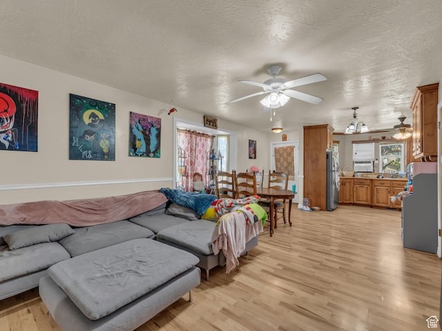 6126 S Middlewood Cir W, Salt Lake City, UT 84118 - living room featuring ceiling fan, light wood-style flooring, plenty of natural light, and a textured ceiling