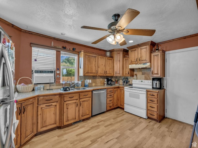 6126 S Middlewood Cir W, Salt Lake City, UT 84118 - kitchen featuring appliances with stainless steel finishes, under cabinet range hood, light wood-type flooring, light countertops, and brown cabinetry