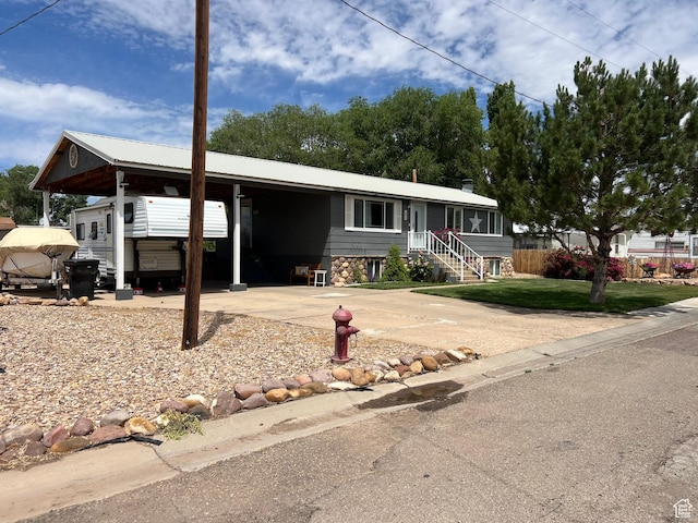 696 S 100 E, Roosevelt, UT 84066 - view of front of home featuring a carport, a front lawn, and concrete driveway