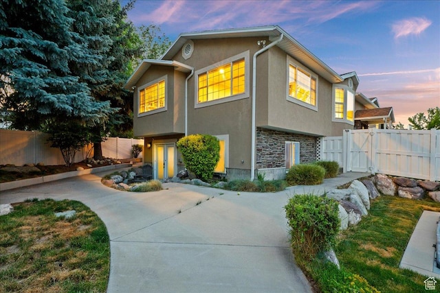 1430 W 6720 S, West Jordan, UT 84084 - view of front of house featuring stone siding, stucco siding, and a fenced backyard