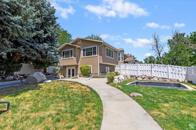 1430 W 6720 S, West Jordan, UT 84084 - view of front of house featuring french doors, a fenced backyard, and stucco siding