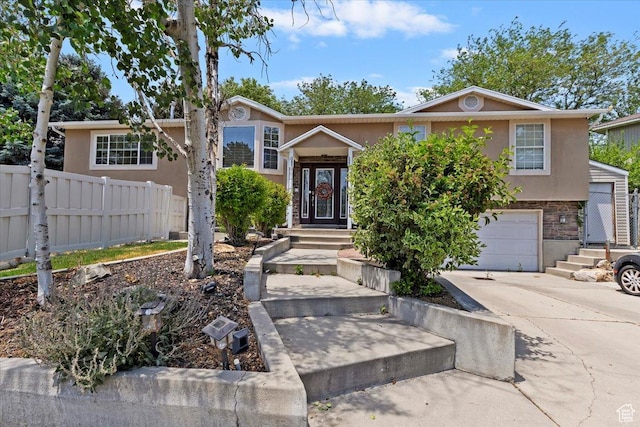 1430 W 6720 S, West Jordan, UT 84084 - view of front facade featuring stucco siding, an attached garage, concrete driveway, and stone siding