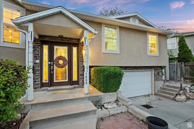 1430 W 6720 S, West Jordan, UT 84084 - entrance to property with stone siding, stucco siding, an attached garage, and driveway