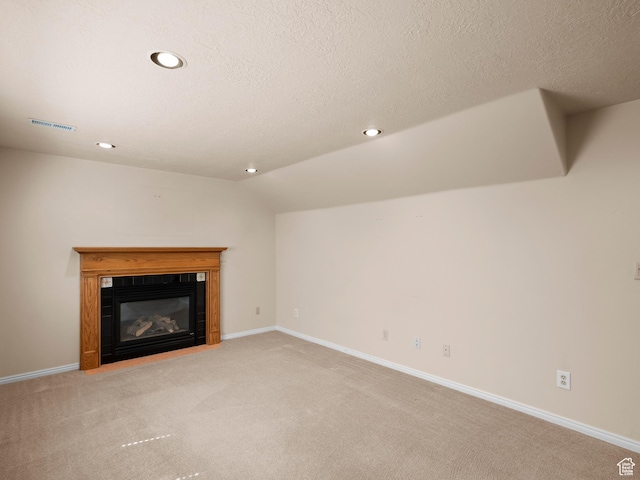 841 E Ramona Ave, Salt Lake City, UT 84105 - unfurnished living room with light carpet, a fireplace with flush hearth, recessed lighting, lofted ceiling, and a textured ceiling