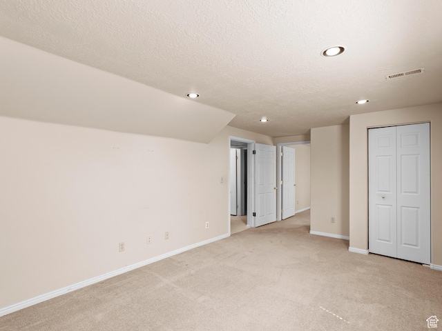 841 E Ramona Ave, Salt Lake City, UT 84105 - unfurnished bedroom with light colored carpet, recessed lighting, a textured ceiling, and a closet