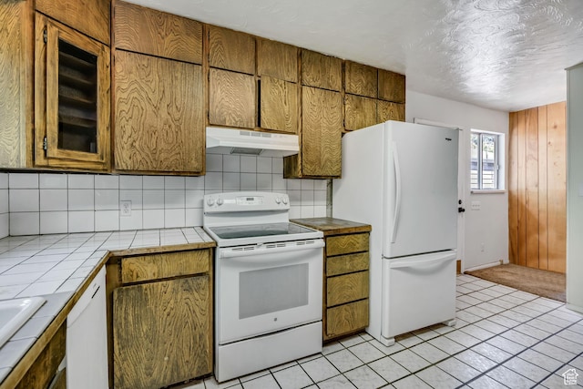 787 E 4800 S, Murray, UT 84107 - kitchen with under cabinet range hood, white appliances, tile counters, backsplash, and a textured ceiling